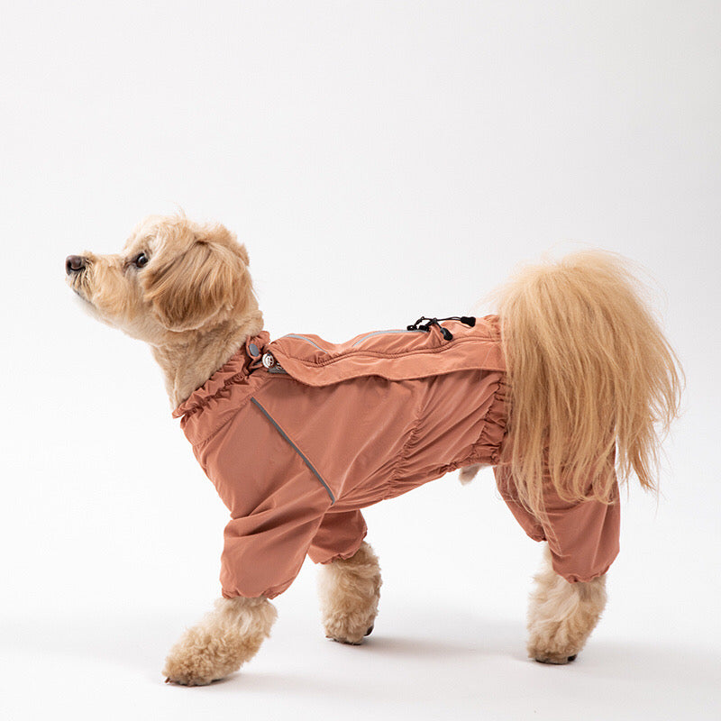 Poodle dog model in a pink raincoat with grey hood side view