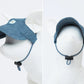 A dog model with a denim sun visor profile and front view.
